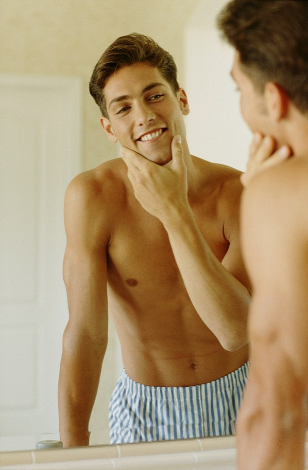 Man Looking at Himself In Front of Mirror